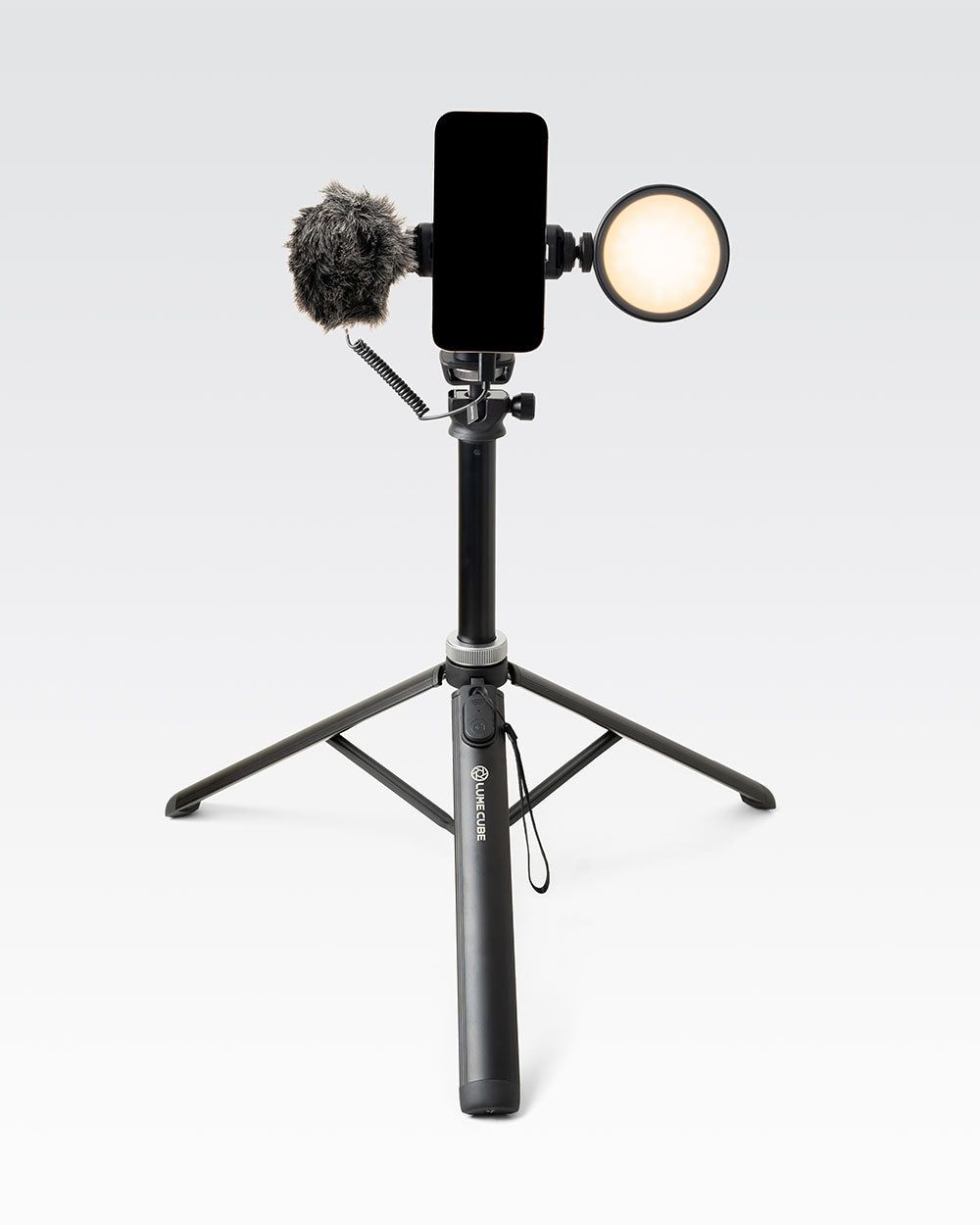 Professional content creation desk setup with studio lights and streaming phone
