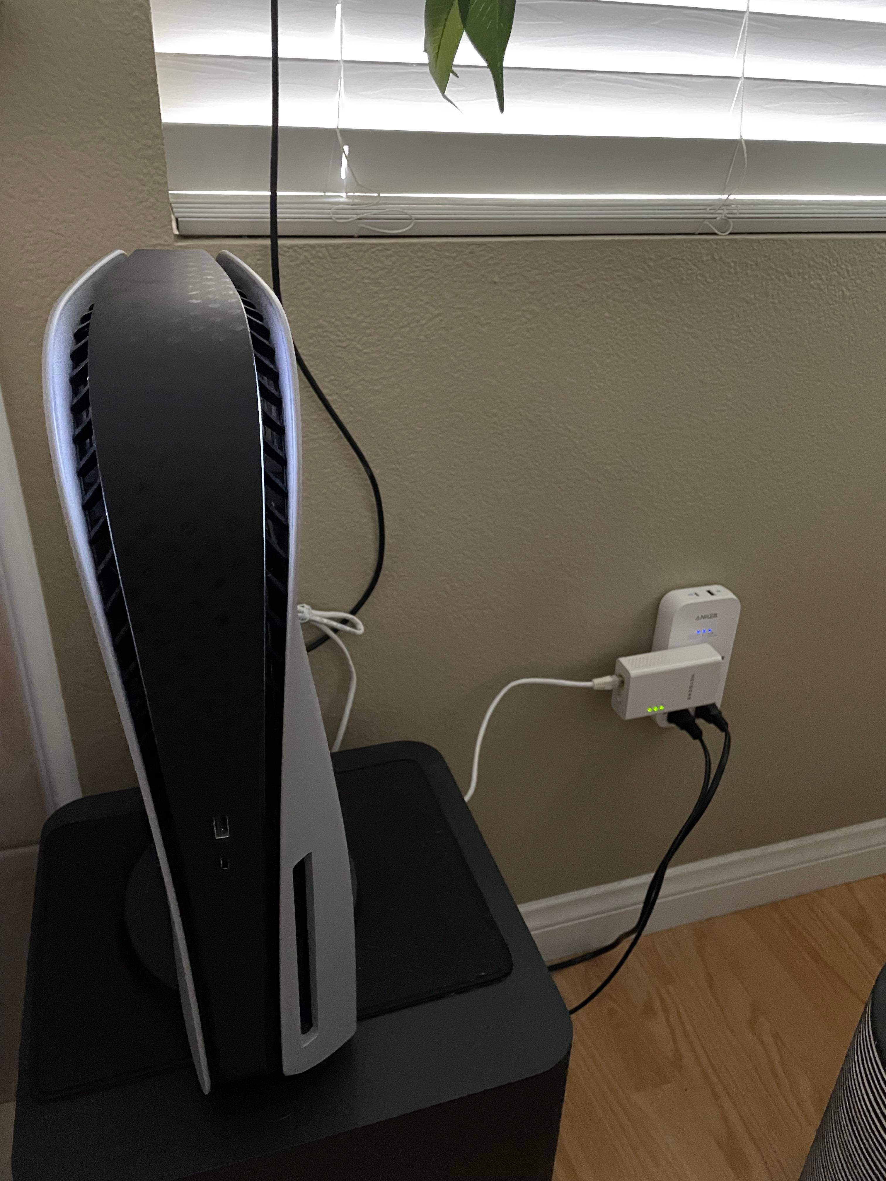 Cat 6 Ethernet cable plugged into the back of a PlayStation 5 console