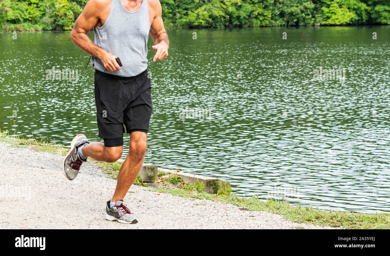 Athlete wearing running earbuds listening to workout pace cues